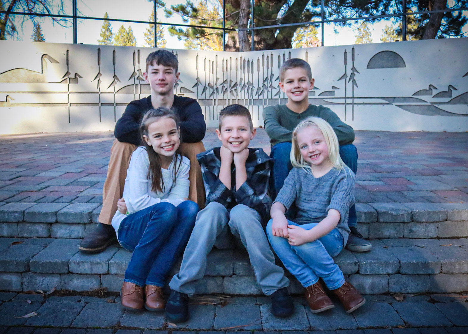 Five children group portrait on stone steps